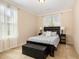 Comfortable bedroom featuring a dark wood bed frame, carpet floors, and plentiful natural light at 3557 S Beaver Ln, Raleigh, NC 27604
