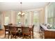 Inviting dining room features a wooden table with comfortable chairs and large windows for natural light at 3557 S Beaver Ln, Raleigh, NC 27604
