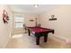 Large game room featuring a pool table, carpet floors, and unique wall decorations at 3557 S Beaver Ln, Raleigh, NC 27604