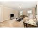 Relaxing living room featuring carpet floors, neutral color walls, and bright natural light at 3557 S Beaver Ln, Raleigh, NC 27604