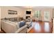Comfortable living room with a fireplace, mounted TV, and abundant natural light at 3557 S Beaver Ln, Raleigh, NC 27604