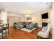 Cozy living room featuring hardwood floors, a fireplace, and comfortable seating at 3557 S Beaver Ln, Raleigh, NC 27604