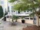 Secluded backyard with a stone patio, fire pit, lush greenery, and space for outdoor entertaining at 4026 Overcup Oak Ln, Cary, NC 27519