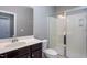 Bathroom featuring a white sink, a framed mirror, and a glass enclosed shower at 4026 Overcup Oak Ln, Cary, NC 27519