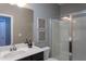 Clean bathroom with a single sink vanity, mirror, and glass-enclosed shower for modern living at 4026 Overcup Oak Ln, Cary, NC 27519