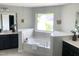 Bright bathroom features a soaking tub with a large window and dual vanities at 4026 Overcup Oak Ln, Cary, NC 27519