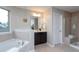 Elegant bathroom featuring a standalone soaking tub, tiled shower, and modern vanity with storage at 4026 Overcup Oak Ln, Cary, NC 27519