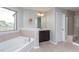 A bathroom showcasing a tub, vanity and glass shower at 4026 Overcup Oak Ln, Cary, NC 27519