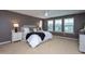 Cozy bedroom featuring a ceiling fan, soft carpet, and natural light from the multiple windows at 4026 Overcup Oak Ln, Cary, NC 27519