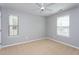 Clean, bright bedroom with neutral walls, carpeted floors, and large window at 4026 Overcup Oak Ln, Cary, NC 27519