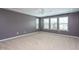 Bedroom featuring neutral walls, carpet flooring, a ceiling fan and three windows at 4026 Overcup Oak Ln, Cary, NC 27519