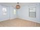 Bedroom with three windows, neutral colored walls and floors, and a modern light fixture at 4026 Overcup Oak Ln, Cary, NC 27519
