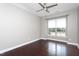 A gray bedroom features hardwood floors and a modern ceiling fan at 4026 Overcup Oak Ln, Cary, NC 27519