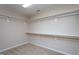 A walk-in closet with shelves and carpet at 4026 Overcup Oak Ln, Cary, NC 27519