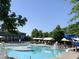 Resort-style community pool with a slide, covered lounge areas, and lifeguard stands, creating a relaxing atmosphere at 4026 Overcup Oak Ln, Cary, NC 27519