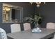 Close-up of dining room displaying a modern table setting with plates, flowers, and a stylish mirror at 4026 Overcup Oak Ln, Cary, NC 27519