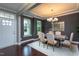 Welcoming dining room with modern table, six chairs, stylish lighting, and views to front yard at 4026 Overcup Oak Ln, Cary, NC 27519