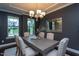 Dining room with modern light fixture and six upholstered chairs at 4026 Overcup Oak Ln, Cary, NC 27519