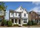 Charming two-story home with white brick, manicured landscaping, and a welcoming front entrance at 4026 Overcup Oak Ln, Cary, NC 27519