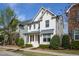 Beautiful two-story home featuring white brick, elegant columns, and landscaping with a cozy front porch at 4026 Overcup Oak Ln, Cary, NC 27519