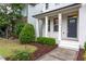 Inviting front porch with elegant columns, a stylish front door, and well-maintained landscaping for curb appeal at 4026 Overcup Oak Ln, Cary, NC 27519