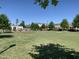 Common green space with trees and well maintained lawn, gazebo, and surrounding shops at 4026 Overcup Oak Ln, Cary, NC 27519