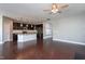 Spacious open-concept kitchen with stainless steel appliances, granite countertops, and dark cabinets next to a dark-wood floored living area at 4026 Overcup Oak Ln, Cary, NC 27519