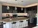 Modern kitchen with stainless steel appliances, granite countertops, and stylish pendant lighting at 4026 Overcup Oak Ln, Cary, NC 27519