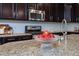 Granite countertops in a kitchen featuring a stainless steel oven, microwave and faucet at 4026 Overcup Oak Ln, Cary, NC 27519