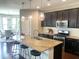 Kitchen with an island with barstool seating and stainless steel appliances at 4026 Overcup Oak Ln, Cary, NC 27519