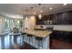 Kitchen island with granite countertops, seating, and stainless steel appliances at 4026 Overcup Oak Ln, Cary, NC 27519