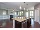 Open kitchen featuring granite countertops, stainless steel appliances, and pendant lighting at 4026 Overcup Oak Ln, Cary, NC 27519
