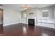Comfortable living room featuring a cozy fireplace, built-in shelving, and plenty of natural light from multiple windows at 4026 Overcup Oak Ln, Cary, NC 27519