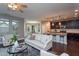 Open-concept living room with hardwood floors, connecting kitchen and dining areas at 4026 Overcup Oak Ln, Cary, NC 27519