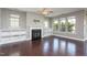 Inviting living room featuring hardwood floors, built-in shelving, a fireplace, and ample natural light at 4026 Overcup Oak Ln, Cary, NC 27519