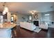 Open-concept living room with a fireplace, hardwood flooring, and an island-style kitchen at 4026 Overcup Oak Ln, Cary, NC 27519