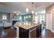 Open floor plan showcasing a fireplace, kitchen island, and dining area at 4026 Overcup Oak Ln, Cary, NC 27519