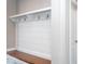 Functional mudroom featuring built-in bench with hooks, storage cabinets, and clean, modern design at 4026 Overcup Oak Ln, Cary, NC 27519