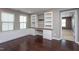 Office space with wood floors, built-in shelves, cabinets, and two windows for natural light at 4026 Overcup Oak Ln, Cary, NC 27519