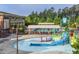 Zero entry pool with slide and splash park at Amberly residents club at 4026 Overcup Oak Ln, Cary, NC 27519