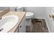 Cozy half bathroom with a single sink vanity and white toilet at 4507 Lazyriver Dr, Durham, NC 27712