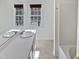Bathroom with a white vanity, large mirror, and a shower and tub combo at 4507 Lazyriver Dr, Durham, NC 27712