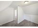 Upstairs bedroom with slanted ceilings, neutral carpet, and a small closet at 4507 Lazyriver Dr, Durham, NC 27712