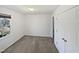 Neutral bedroom featuring double door closet, new carpet, and a bright window at 4507 Lazyriver Dr, Durham, NC 27712