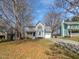 Charming two-story home with a well-manicured lawn and mature trees, painted in light blue at 4507 Lazyriver Dr, Durham, NC 27712