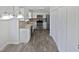 Well-lit kitchen boasts stainless appliances, mosaic backsplash, white cabinets and hardwood floors at 4507 Lazyriver Dr, Durham, NC 27712