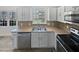 Bright kitchen with stainless steel appliances, light countertops and a window above the sink at 4507 Lazyriver Dr, Durham, NC 27712