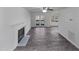 A bright living room features a fireplace, ceiling fan and French doors, showcasing its inviting ambiance at 4507 Lazyriver Dr, Durham, NC 27712