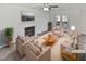 Bright living room with fireplace, neutral furniture, hardwood floors and French doors to the backyard at 4507 Lazyriver Dr, Durham, NC 27712