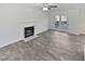 A bright living room features a fireplace, ceiling fan and French doors, showcasing its inviting ambiance at 4507 Lazyriver Dr, Durham, NC 27712